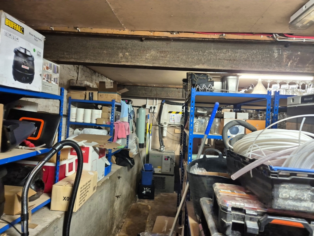 Rear storage room with shelving surveyed during commercial building measurement