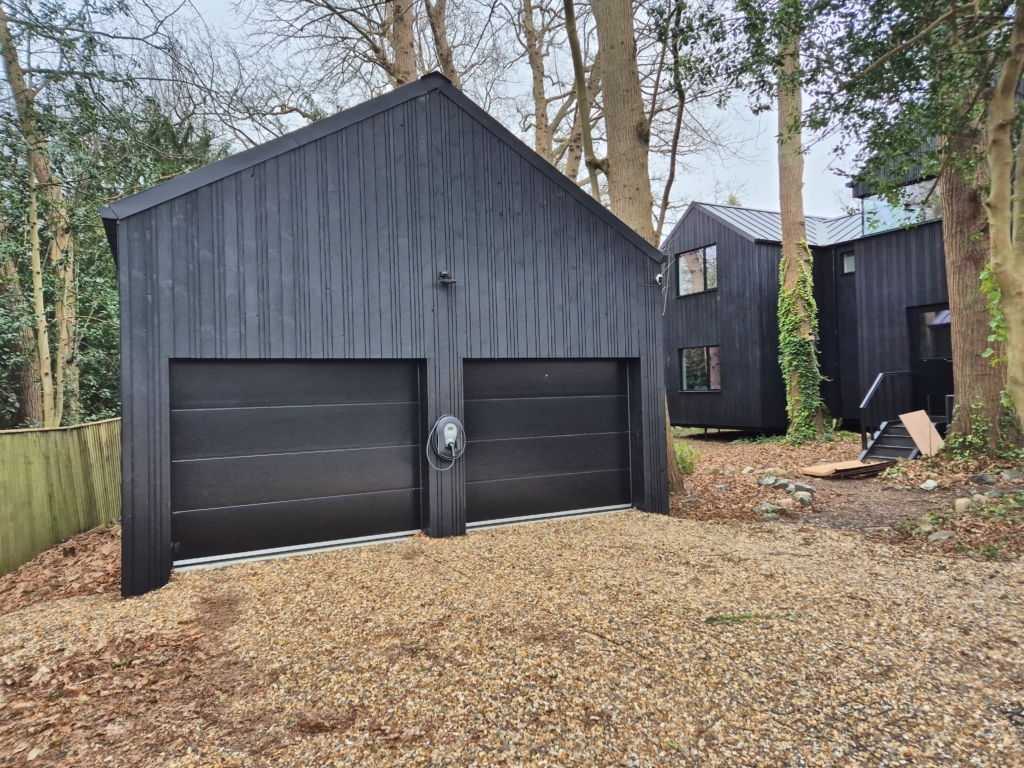 Double garage with black timber cladding at Woodland House, Tunbridge Wells TN2 — topographical survey by 360 Measurements