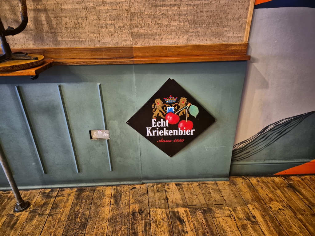 Vintage Echt Kriekenbier sign on cork wall inside Tunbridge Wells cafe